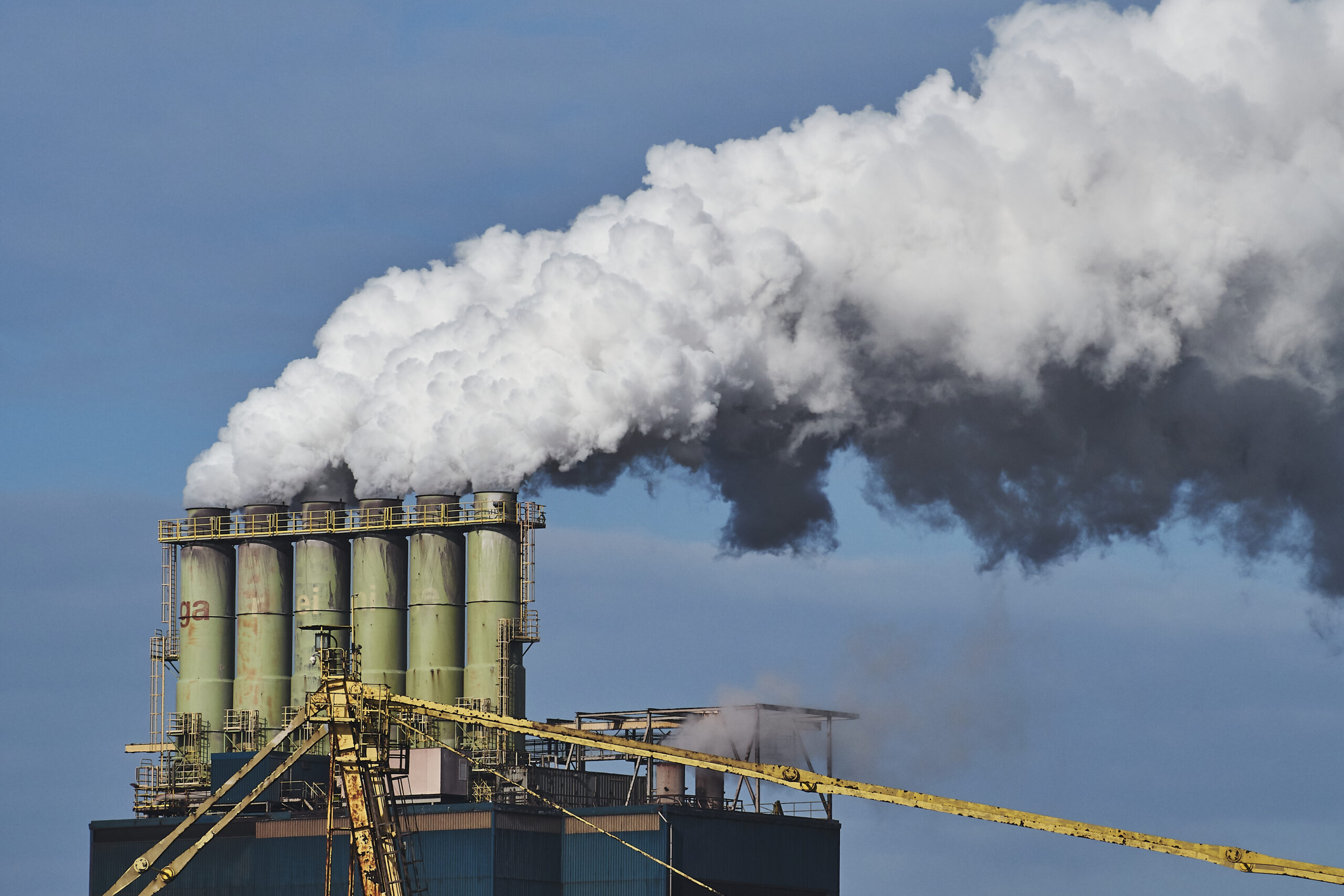 dust emission from industrial factory scaled Regulatory Limits for Dust Emissions: What Every Site Manager Should Know 3 Dust Emission From a Factory